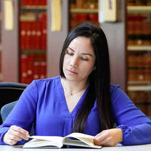 A student reads a book in the library.