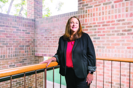 Kristin Gawlik (B.B.A. ’96, M.B.A. ’98) stands in the stairwell of the Greehey School of Business.