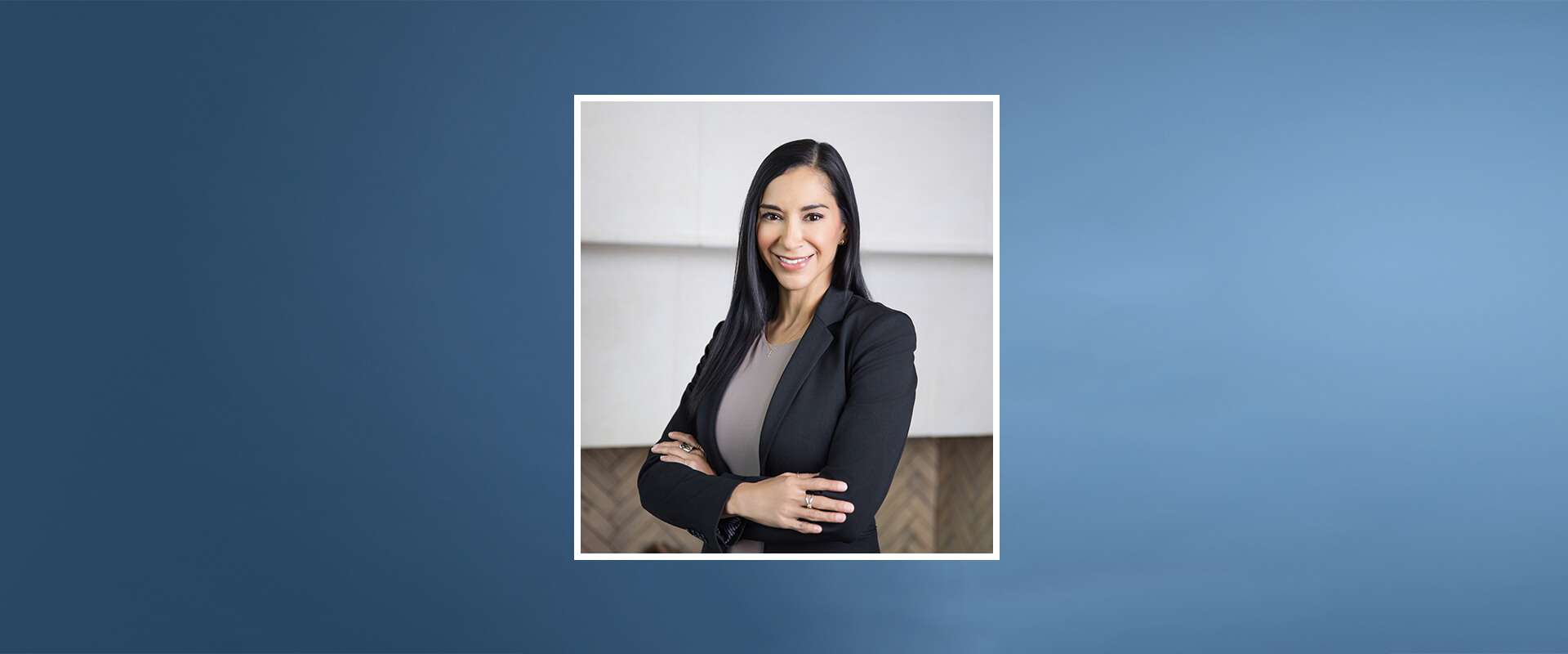 MBA student Clara Guerrero in front of a white wall.