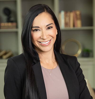 MBA student Clara Guerrero in front of a bookcase.