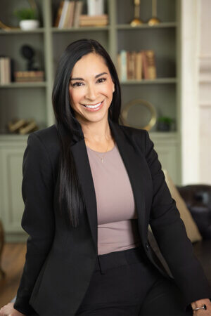 MBA student Clara Guerrero in front of a bookcase.