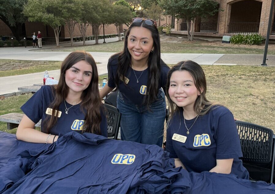 University Programing Council students hand out UPC shirts.