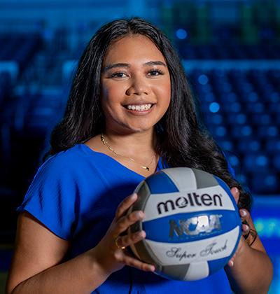 ShaLi Niu (M.P.A. ’25) holds a Volleyball in Greehey Arena.