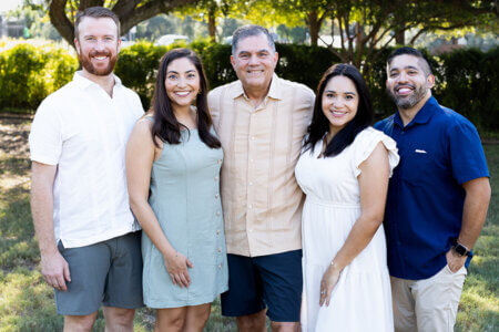The Huertas and Straters take a family photo at Landa Library.