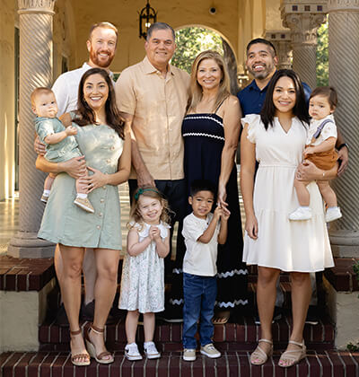 The Huertas and Straters take a family photo at Landa Library.