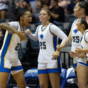 Players with the St. Mary's Women's Basketball team celebrate during their game against Sul Ross State University.