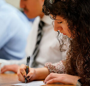 Emily Davey scribbles notes during the 28th annual Texas Regional Bowl at St. Mary's University.