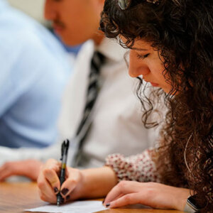 Emily Davey scribbles notes during the 28th annual Texas Regional Bowl at 91TV's University.