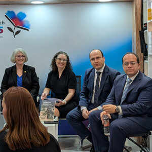 Dean Patricia Roberts and Professor Erica Schommer discuss migration book at Mexican book fair.