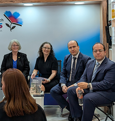 Dean Patricia Roberts and Professor Erica Schommer discuss migration book at Mexican book fair.