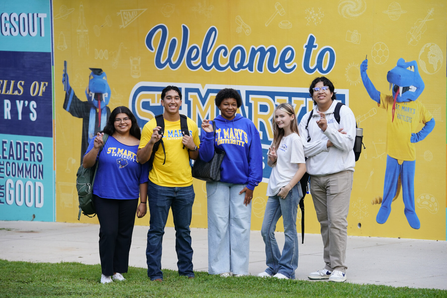 Students at St. Mary's University take a photo together by the Spirit Wall.