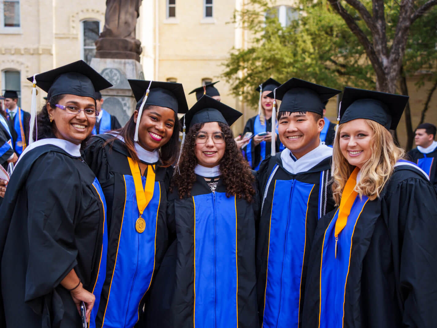 St. Mary's University graduates smile together for a group photo.