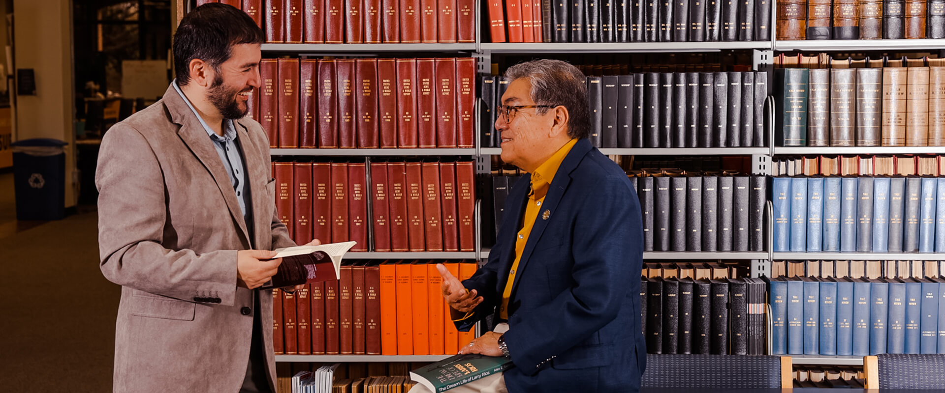 Alex Salinas (B.A. '11, M.A. '19), left, and Rafael Castillo (B.A. '75), visit the St. Mary's Blume Library with their new works of fiction.