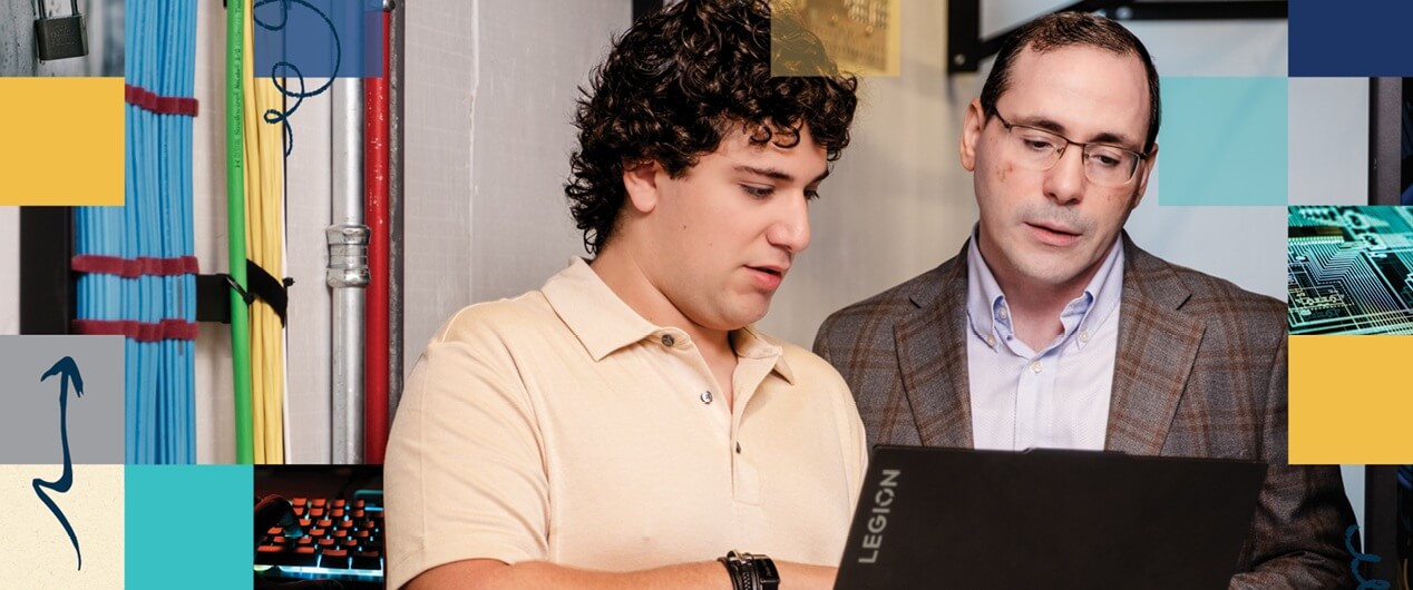 Ayad Barsoum, Ph.D., and Juan Marco Saca Dada review an AI prompt on a labtop.
