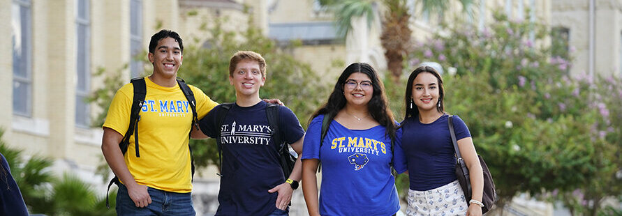 Students at St. Mary's University take a photo together by St. Louis Hall.