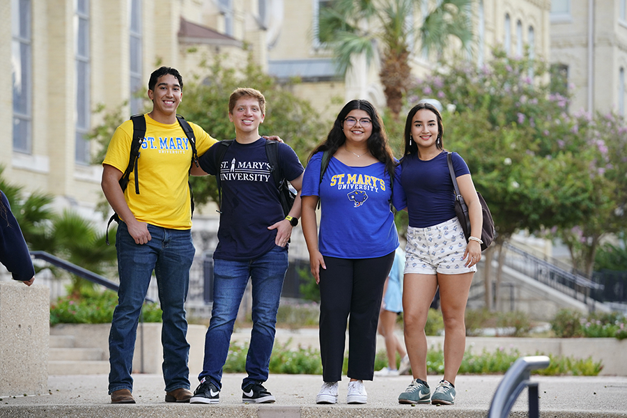 Students at St. Mary's University take a photo together by St. Louis Hall.