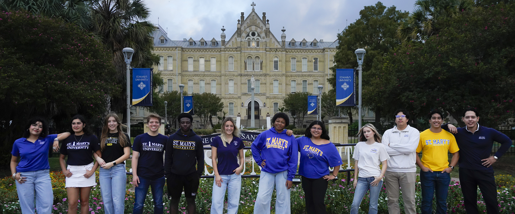 Students at St. Mary's University take a photo together by St. Louis Hall.