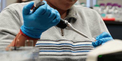 Biology student using equipment.