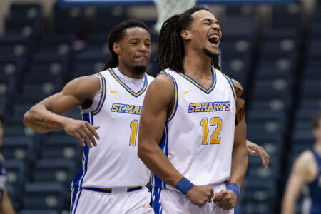 St. Mary's Men's Basketball platers Justin Britt (12) and JJ Walton (1) celebrate during a basketball game. 
