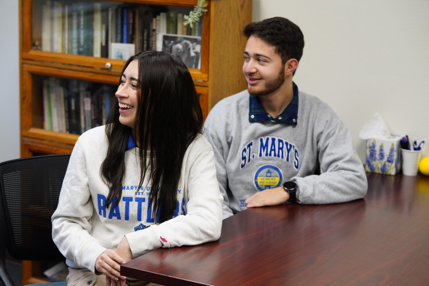 Two students wearing St. Mary's University sweaters smiling.