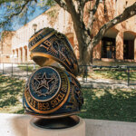 The newly installed Rattler Ring replicas sit on campus near the Barrett Memorial Tower.