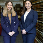 Kendall Michaelis and Caroline Villarreal are photographed in the Sarita Kenedy East Law Library. They were awarded national championship at the ABA Negotiation Competition.