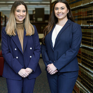 Kendall Michaelis and Caroline Villarreal are photographed in the Sarita Kenedy East Law Library. They were awarded national championship at the ABA Negotiation Competition.