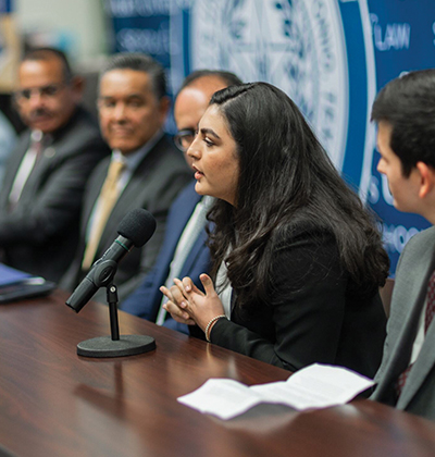 Magnolia Cruz, third-year J.D. student and a co-author, speaks at a panel about the binational migration book.