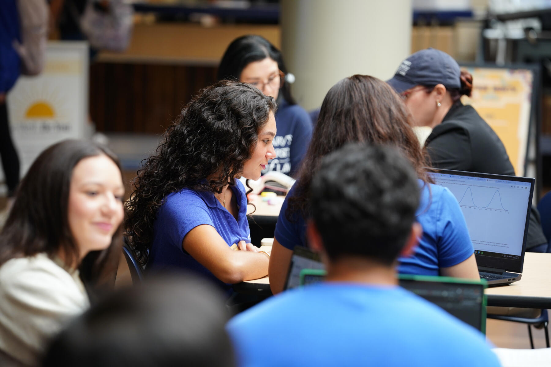 Group of people sit at tables in the University Center.