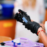 A student hold a piece of biomedical equipment.