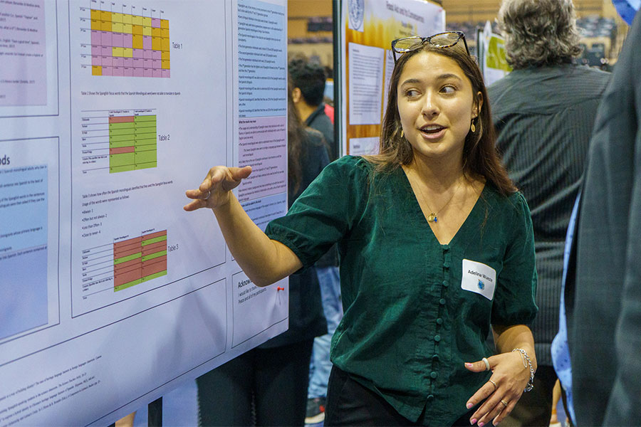 A student displays her poster during the annual St. Mary's University Research Showcase