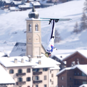 Photo of Olympian Winter Vinecki caught upside down in the air as she competes in the 2026 Winter Olympics in Italy.