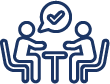 An icon of people seated at a table talking. The person on the left has a speech bubble with a check mark in it.