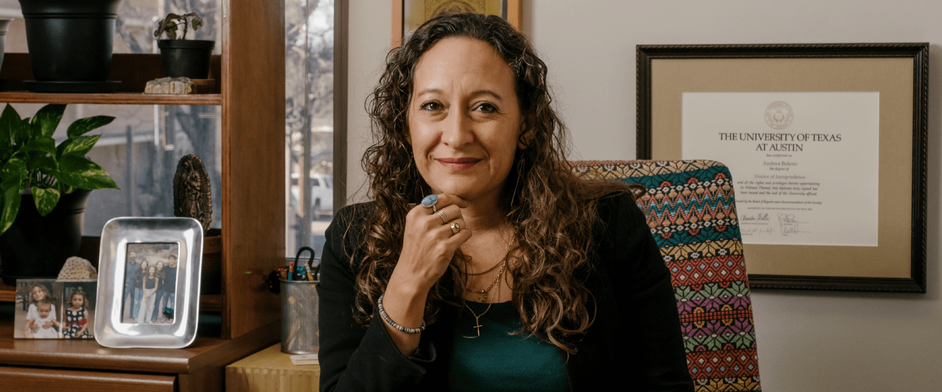 Andrea Beleno Harrington, J.D., sits at her desk in her office in the Center for Legal and Social Justice building.