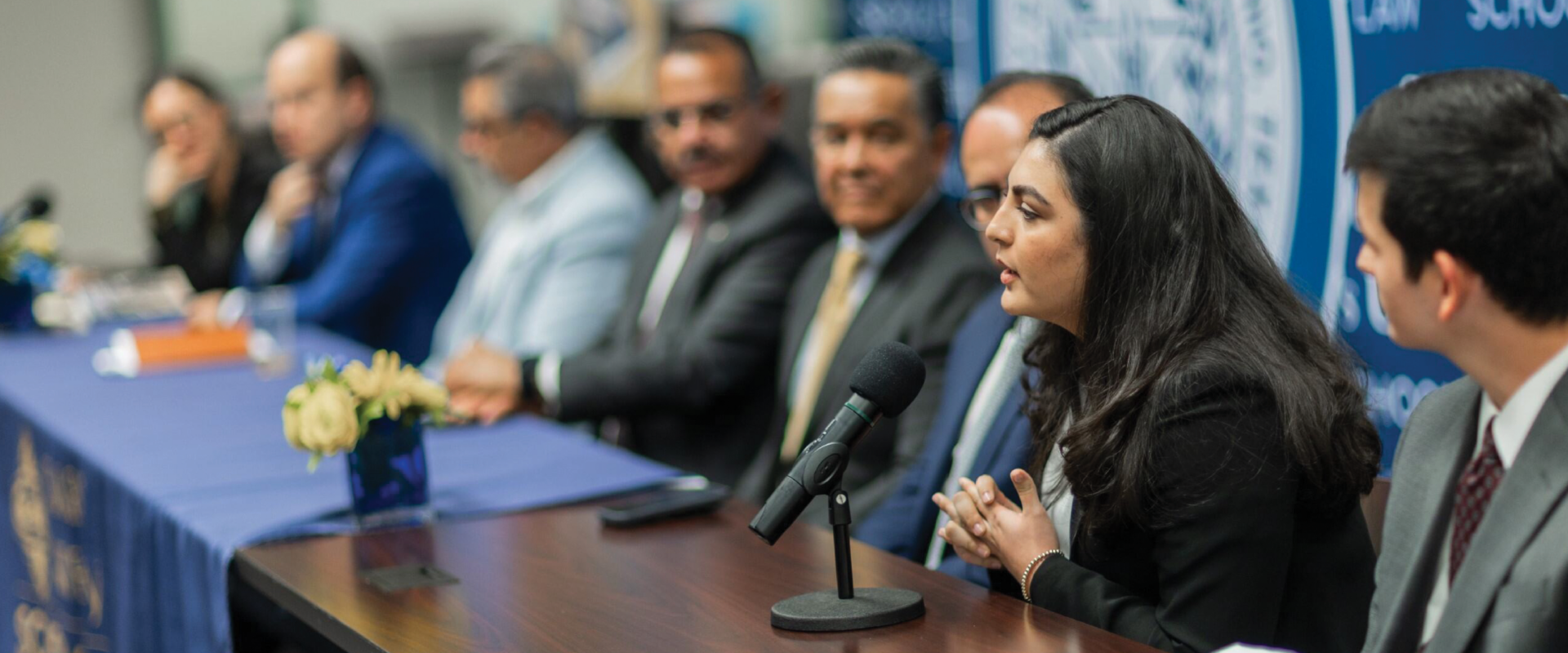 Magnolia Cruz, third-year J.D. student and a co-author, speaks at a panel about the binational migration book.
