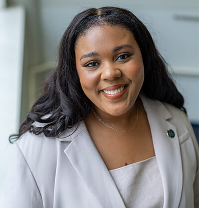 Portrait of Jordyn Roberts in a light lavender suit.