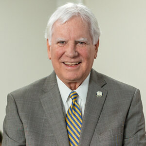 Paul Green in gray suit in classroom in Raba Law Building.