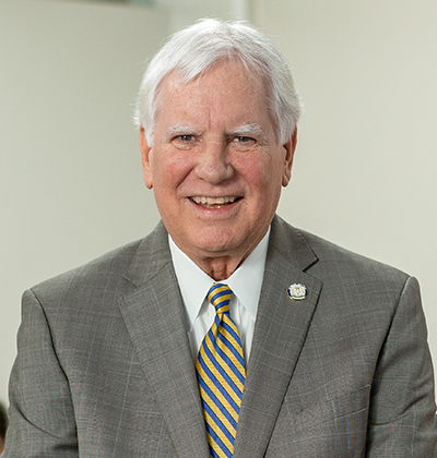 Paul Green in gray suit in classroom in Raba Law Building.