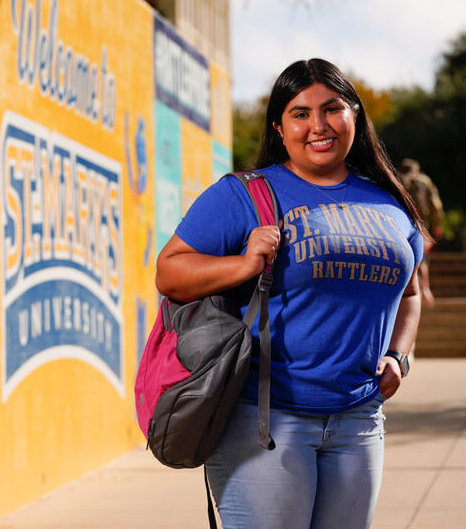 Students smiles as she walks around the St. Mary's Campus.