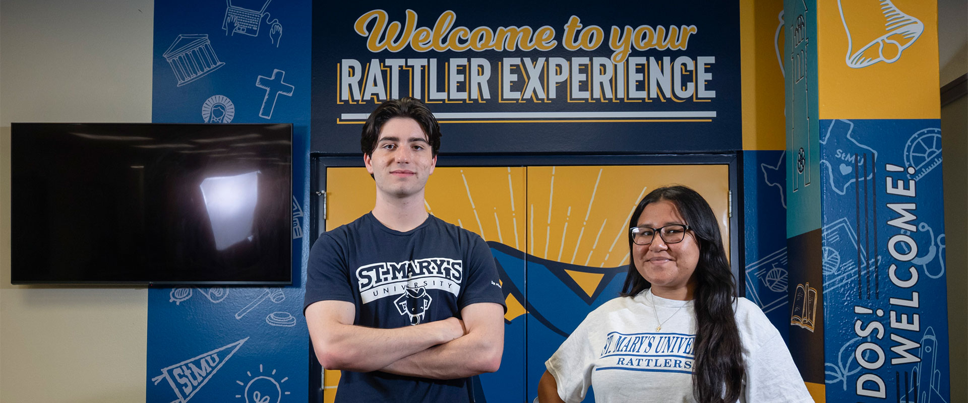 Two Diamondback Tour Guides stand in front of the new Welcome Center.