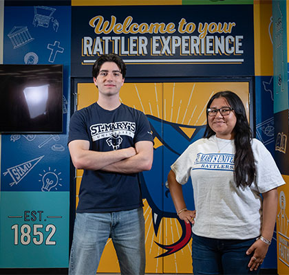 Two Diamondback Tour Guides stand in front of the new Welcome Center.
