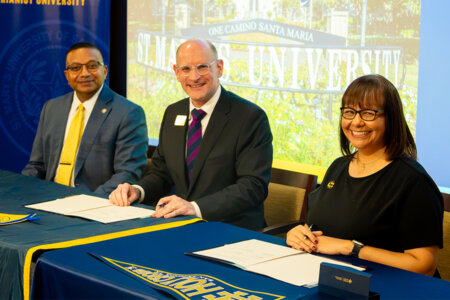 From left, St. Mary's President Winston Erevelles, St. Mary's Provost Jason Pierce and Dina Zamarripa of Holy Cross of San Antonio sign the dual credit partnership.