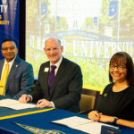 From left, St. Mary's President Winston Erevelles, St. Mary's Provost Jason Pierce and Dina Zamarripa of Holy Cross of San Antonio sign the dual credit partnership.