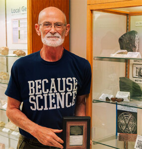 Professor of Environmental Science Professor David Turner, Ph.D., with a meteorite found in Namibia, Africa.