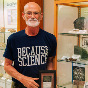 Professor of Environmental Science Professor David Turner, Ph.D., with a meteorite found in Namibia, Africa.