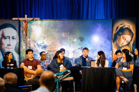 Stephen Garcia, with microphone, sits on a panel at the 2026 Province Assembly in Dayton, Ohio.