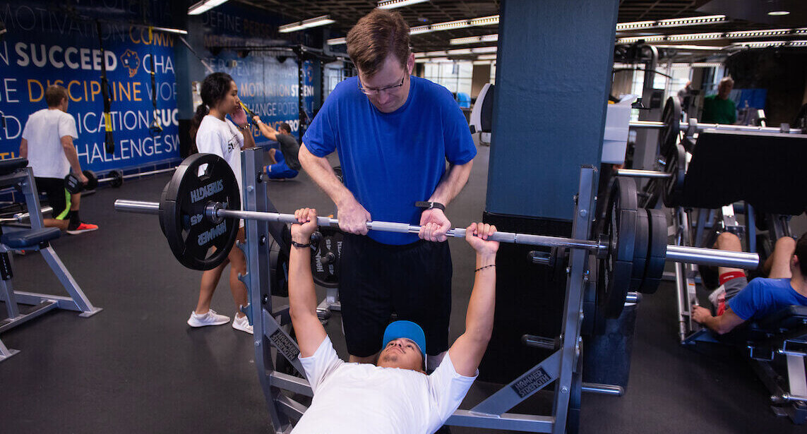 Students use the gym on campus.