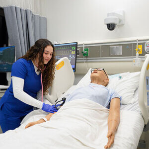 A student practices on a manikin in the simulation lab at St. Mary's University.