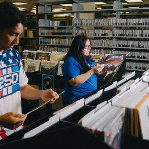 From left, Nicholas Galus, a junior, and Valerie Vallejo, graduate Public History student and an Archives Graduate Assistant for the Blume Library, review their vinyl options.